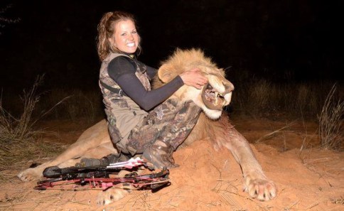 Woman displaying an African lion she is pleased to have killed.  Name unknown, inner state as clear as day.